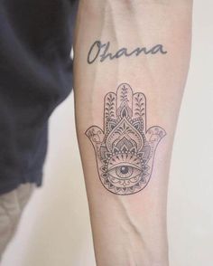 a hamsa tattoo with the word obama written on it and an eye in the middle