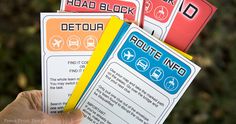 a person holding up four signs in their hand that read route no, road block and detour