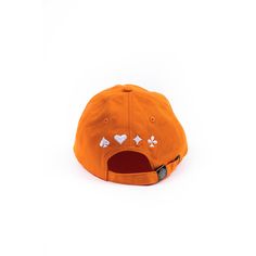 an orange baseball cap with hearts and clovers embroidered on the front, against a white background