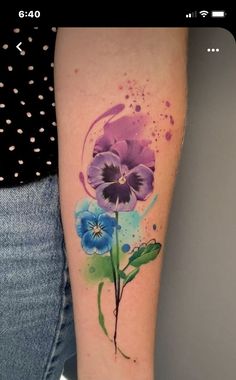 a woman's arm with flowers painted on it