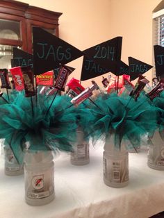 several mason jars filled with candy and decorated with signs that read jags, 20th birthday