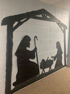 a nativity scene made out of paper with the silhouettes of jesus and mary