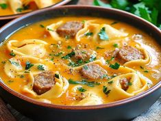 two bowls filled with pasta and meat soup