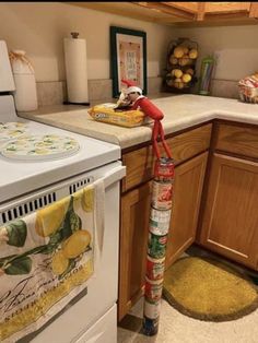 a kitchen with an oven, stove and yellow rugs on the floor in front of it