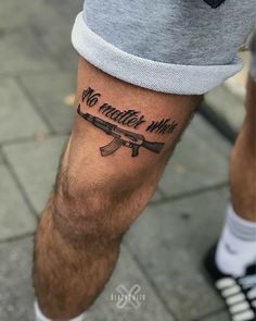 a man with a tattoo on his leg that says no matter who he is holding