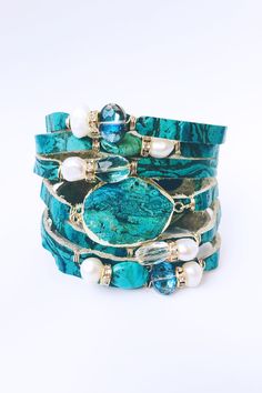 "Gorgeous turquoise split/shredded leather cuff in embossed leather...adorned with a 24k gold electroplated edge focal, surrounded by freshwater pearls, turquoise, crystals and faceted glass beads....accented with sparkly crystal rondels plated in 24k gold. Adjustable to fit wrists from 7 - 7 3/4\" The width of the cuff is 1 3/4\" wide at the snaps, but expands up to 3\" in the front to accommodate the gemstones." Turquoise Crystals, Leather Cuff Bracelet, Fresh Water Pearls, Leather Cuffs Bracelet, Water Pearls, Faceted Glass, Leather Cuffs, Adjustable Bracelet, Embossed Leather