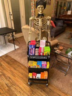 a skeleton sitting on top of a cart filled with candy