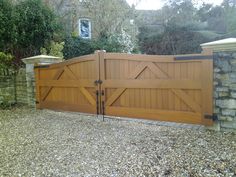 a large wooden gate in front of a stone wall