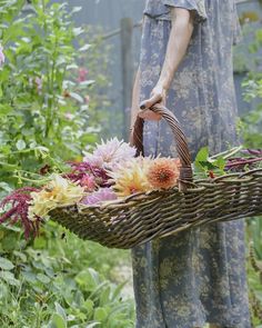 a woman holding a basket with flowers in it and the words bonjur written below