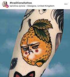 a man with a tattoo on his arm has a cat in front of an orange