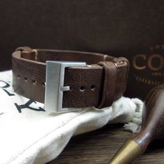 "At Cozy Handmade, we pride ourselves on using the highest quality materials for our products. This watch strap (NAT2) is made of premium full grain Italian veg tanned leather from one of the best tanneries in Italy. The leather features gorgeous texture and natural characteristics which will give your watch an instant rugged and vintage stylish look. Its appearance will get even better with time as it acquires patina, wrinkles and marks. This watch strap is designed to have no excess strap tail Rugged Waxed Finish Watch Bands For Everyday Use, Everyday Brown Watch With Waxed Finish, Brown Vegetable Tanned Leather Watch Bands For Everyday Use, Nato Strap Watches, Brown Leather Strap Watch, Apple Watch Sizes, Minimalist Watch, Tan Cowhide, Nato Strap