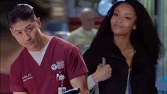 a man and woman in scrubs walking together