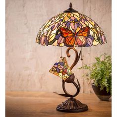 a table lamp with two butterflies on it