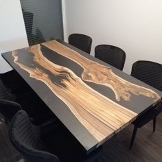 a wooden table with chairs around it in an office setting that looks like a piece of wood