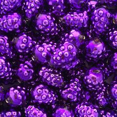 many purple beads are stacked together in a pile