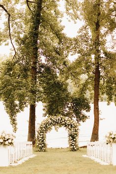 Lakeside Wedding Ceremony with Large Floral Arch with Greenery and White Roses Arch With Greenery, Lakeside Wedding Ceremony, Long Stem Bouquet, Classic White Wedding, White Flower Arrangements, Lakeside View, Wedding Lake, White Drapery