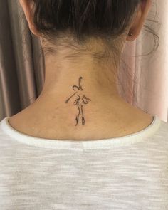 a woman with a small tattoo on her neck