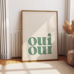 a framed poster with the words oui oui on it in front of a radiator