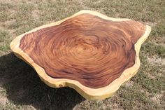 a wooden table sitting in the grass