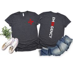 two t - shirts with the words emergency and an american flag on them next to some jeans