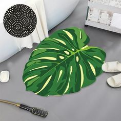 a large green leaf shaped rug sitting on top of a floor next to a bathtub