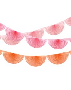 pink and orange paper parasols are hanging from a string on a white background