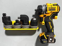 a cordless drill and impactor on a shelf with other tools attached to it