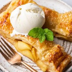 an apple pie on a plate with ice cream