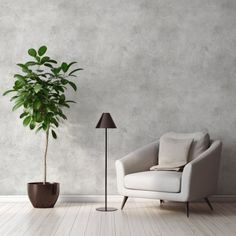 a living room with a chair, lamp and potted plant on the floor next to it