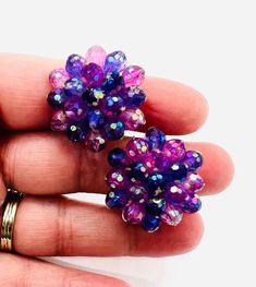 Vintage Signed WEST GERMANY Faceted Lucite Cluster Beaded Earrings. Purple and pink AB beads. In excellent vintage condition with minimal age appropriate wear. Signed on clips. Measure 1 1/8 inches across. Clip backs secure. Vintage Beaded Earrings For Party, Handmade Party Clip-on Earrings With Round Beads, Vintage Beaded Clip-on Earrings For Party, Pink Beaded Earrings With Bead Caps, Vintage Beaded Earrings With Colorful Beads, Vintage Colorful Round Beaded Earrings, Colorful Vintage Beaded Earrings, Vintage Purple Earrings For Party, Handmade Pink Clip-on Earrings For Party