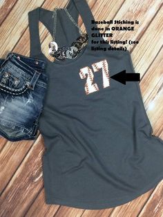 a tank top with the letter t on it next to some shorts and a pair of shoes