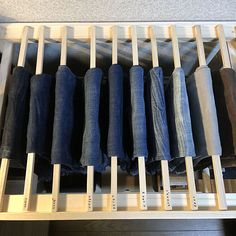 several pairs of jeans are lined up in a drawer