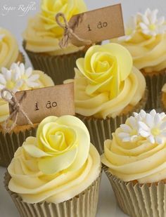 several cupcakes with yellow frosting and white flowers on them are labeled i do