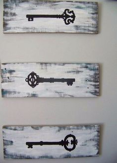 three wooden signs with keys painted on them