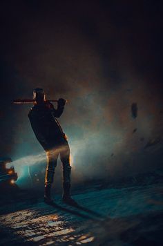 a man holding a baseball bat in the dark