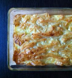 a casserole in a glass baking dish on a blue tableclothed surface