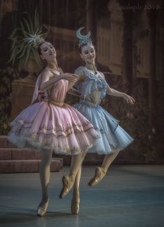 two ballerinas dressed in pink and blue tutus