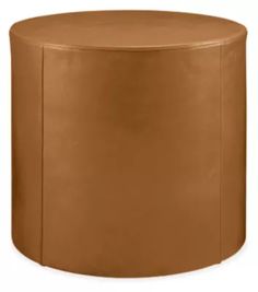 a brown leather stool with rounded legs