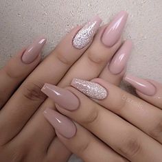 two hands with pink and silver nail polishes on their nails, one is holding the other