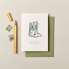 a card with a drawing of a pair of boots on it next to a pencil and eraser