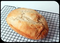 a loaf of bread sitting on top of a cooling rack