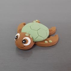 a small toy turtle with eyes on it's back