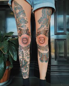 the legs and ankles of a woman with tattoos on her body are covered in intricate designs