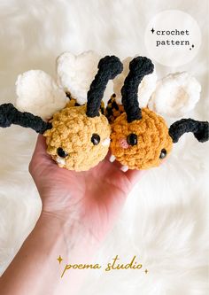 two crocheted bugs sitting on top of each other in front of a white background