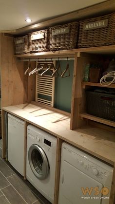 a washer and dryer in a laundry room with baskets on the shelves above