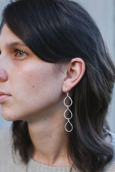 These silver dangle earrings are reminiscent of juicy pears, ripe on the branch, and heavy with the promise of sweet nectar.  Decidedly bohemian, these drop earrings are lovingly crafted with only the highest quality sterling silver wire formed and hammered for just the right sparkle. Long silver earrings are a lovely addition to any outfit and would be especially dramatic paired against solid, darker colors.  Each pair of these hammered silver earrings measures approximately 3 inches long by ½ Nickel-free Dangle Drop Earrings, Everyday Pear-shaped Silver Jewelry, Everyday Hypoallergenic Teardrop Linear Earrings, Everyday Teardrop Linear Earrings, Nickel-free Dangle Teardrop Earrings, Sterling Silver Teardrop Linear Single Earring, Everyday Dangle Drop Earrings With Matching Set, Single Long Drop Teardrop Earring For Everyday, Hypoallergenic Metal Teardrop Earrings For Everyday