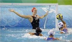 the water polo team is competing in an olympic game, with one player blocking the ball