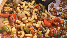 a large pot filled with pasta and vegetables