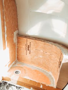 an unfinished bathtub in the corner of a room that is being remodeled with paint