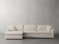 a white couch sitting on top of a gray floor